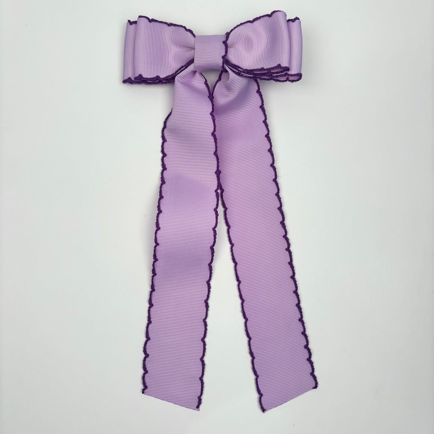 A Patty’s Day Moonstitch Light Purple/Dark Purple Bow